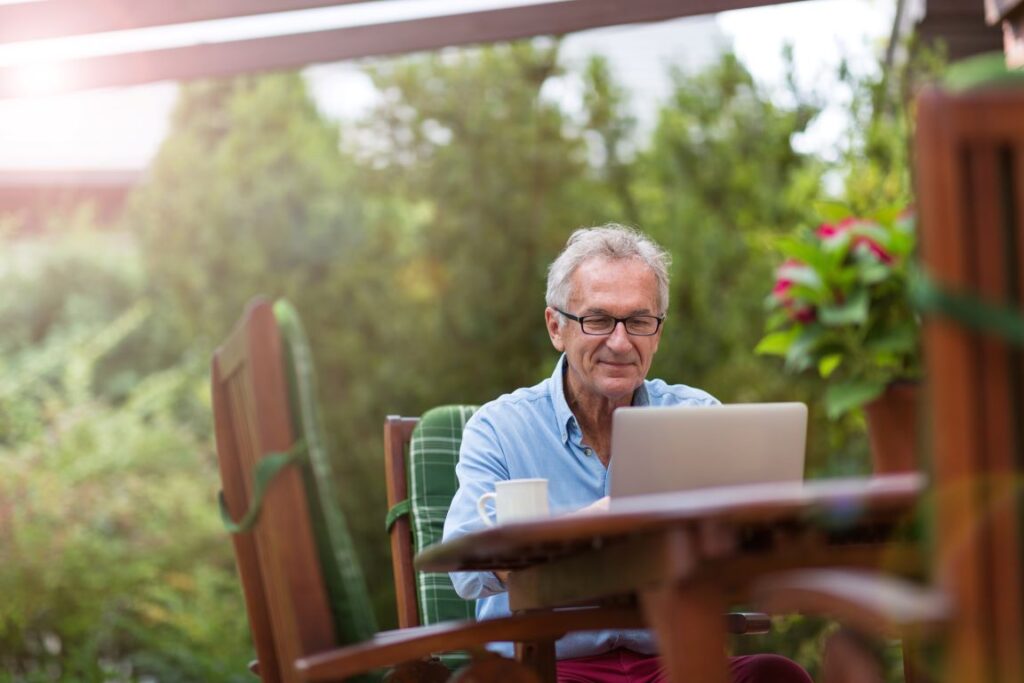 A man researching dental implants on the computer.